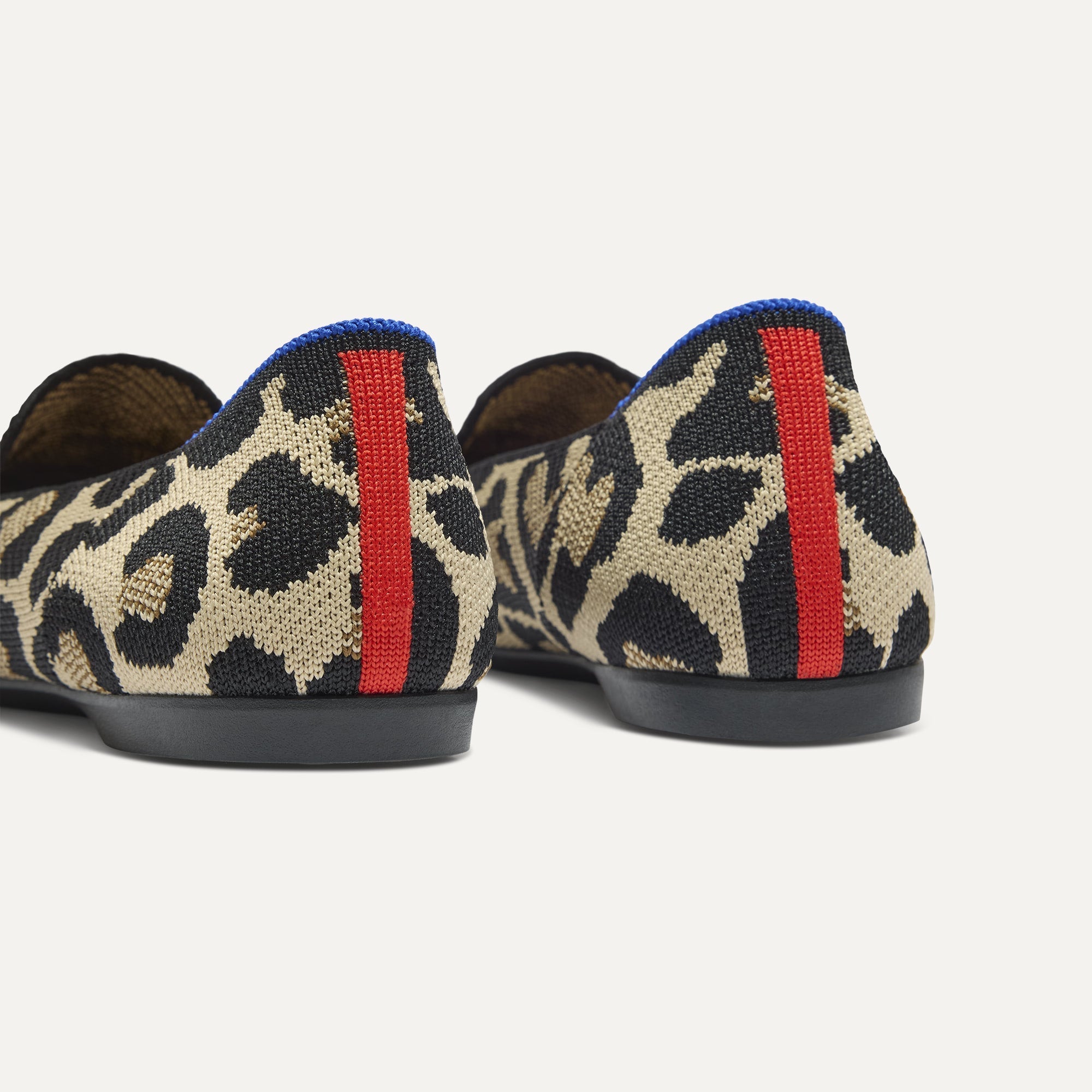 Close up of the heel of The Daily Loafer in Desert Cat, with raised peg outsoles and Rothy's signature blue halo. 