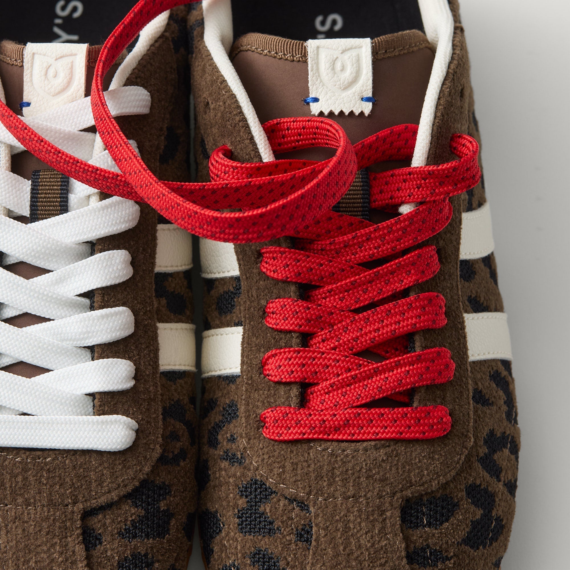 Overlay:: Extra pair of laces included—swap for a new look anytime. | Alt:: Close up of the top of The Ivy Sneaker in ReVelvet Cheetah, showing different lace choices.