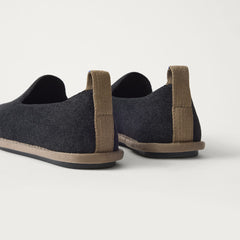 The Mini Loafer in ReVelvet™ Black shown from the back view with the heel detail.
