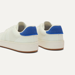 Close up of the heel of The Kids Stretch Sneaker in Turbo, with Rothy's signature blue halo. 