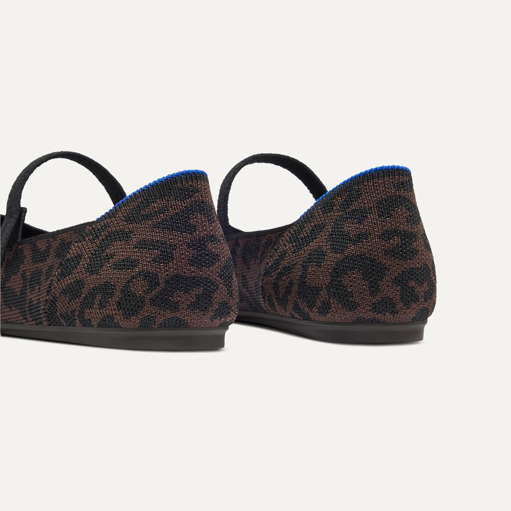 Close up of the heel of The Square Mary Jane in Classic Cheetah, with Rothy's signature blue halo. 